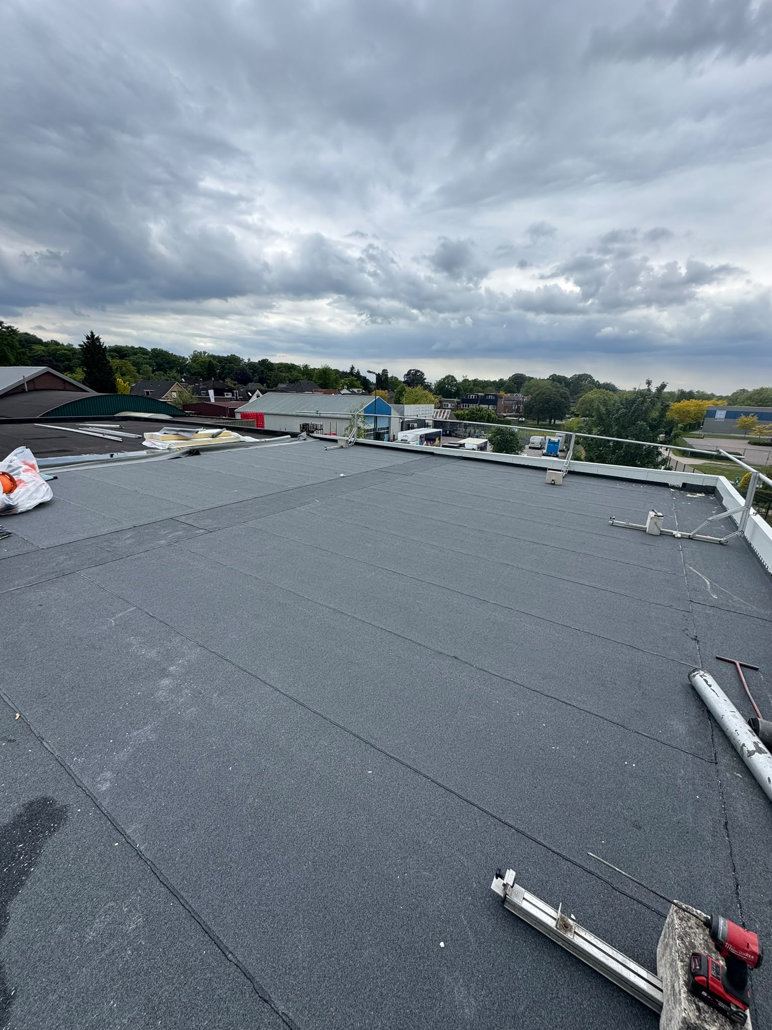 Groot plat dak na renovatie met nieuwe bitumen dakbedekking